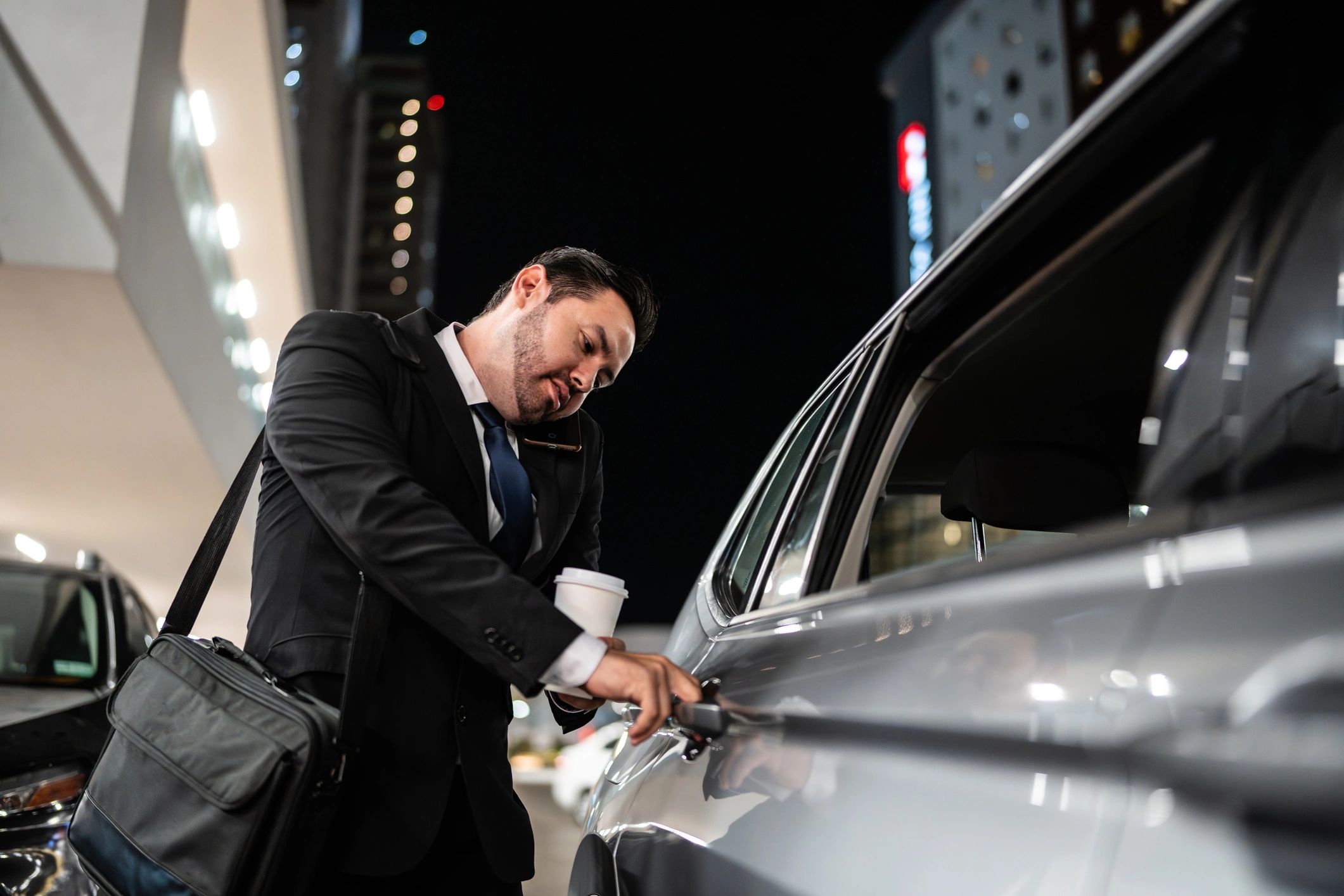 Passenger entering a taxi for an airport transfer