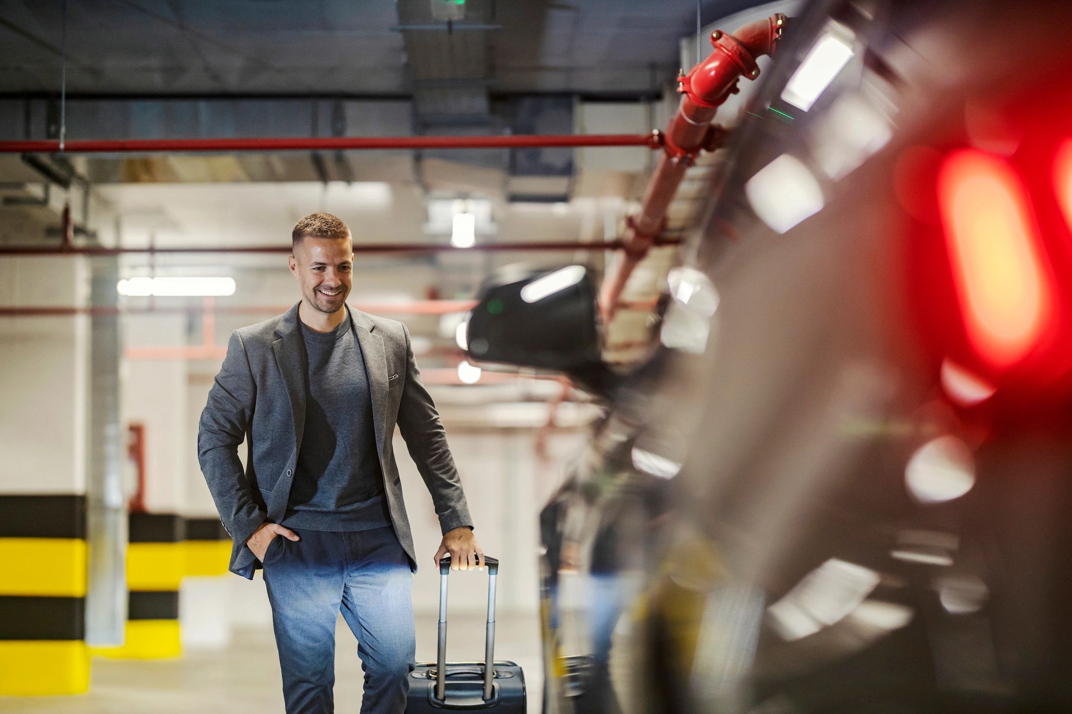 Business traveler with luggage walking to a car for pickup