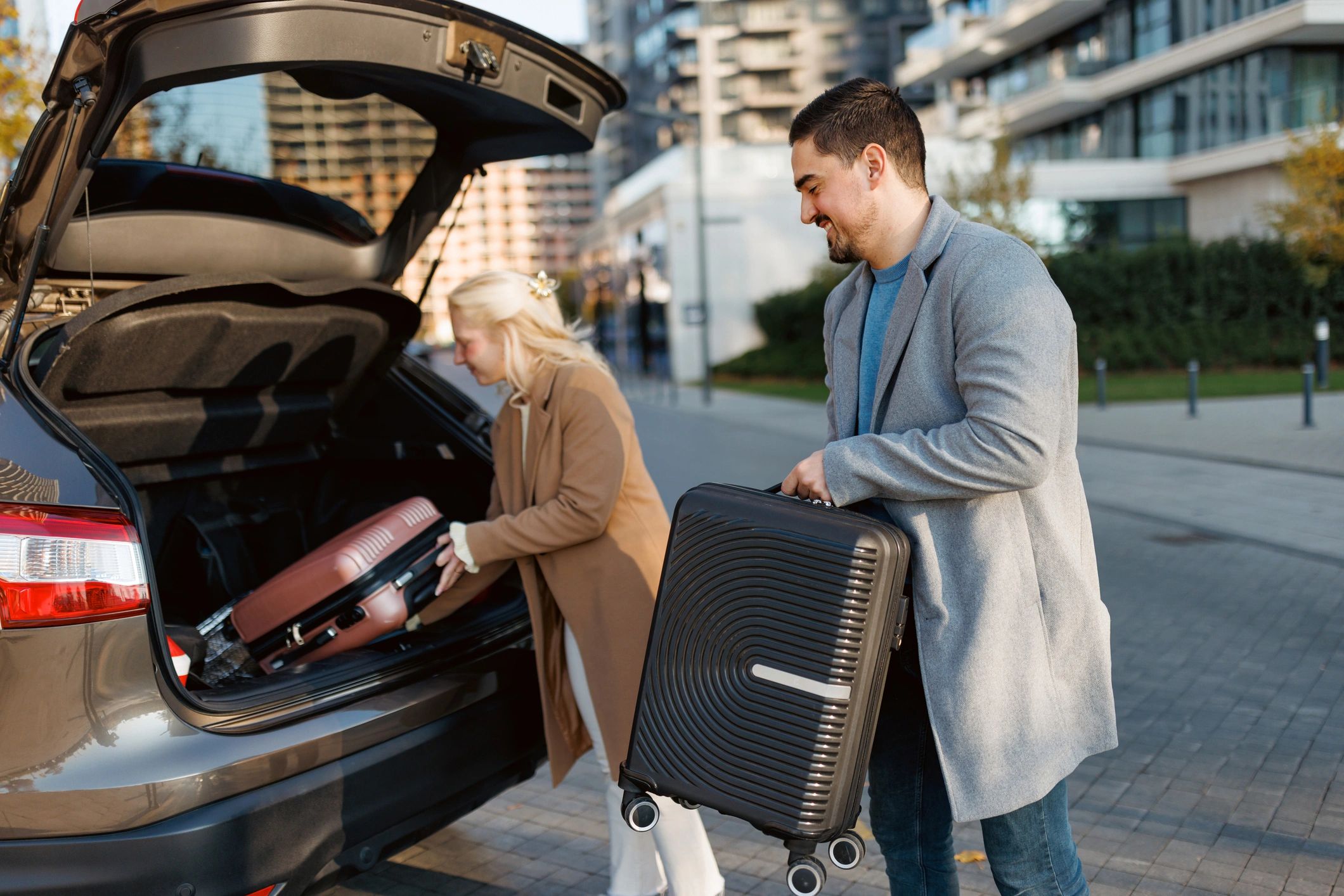 Couple preparing luggage for a road trip